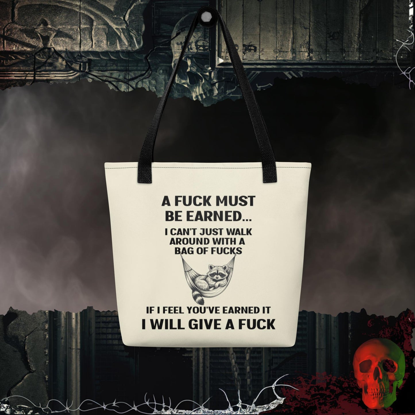 Tote bag with the phrase “A Fuck Must Be Earned” and a raccoon lounging in a hammock.